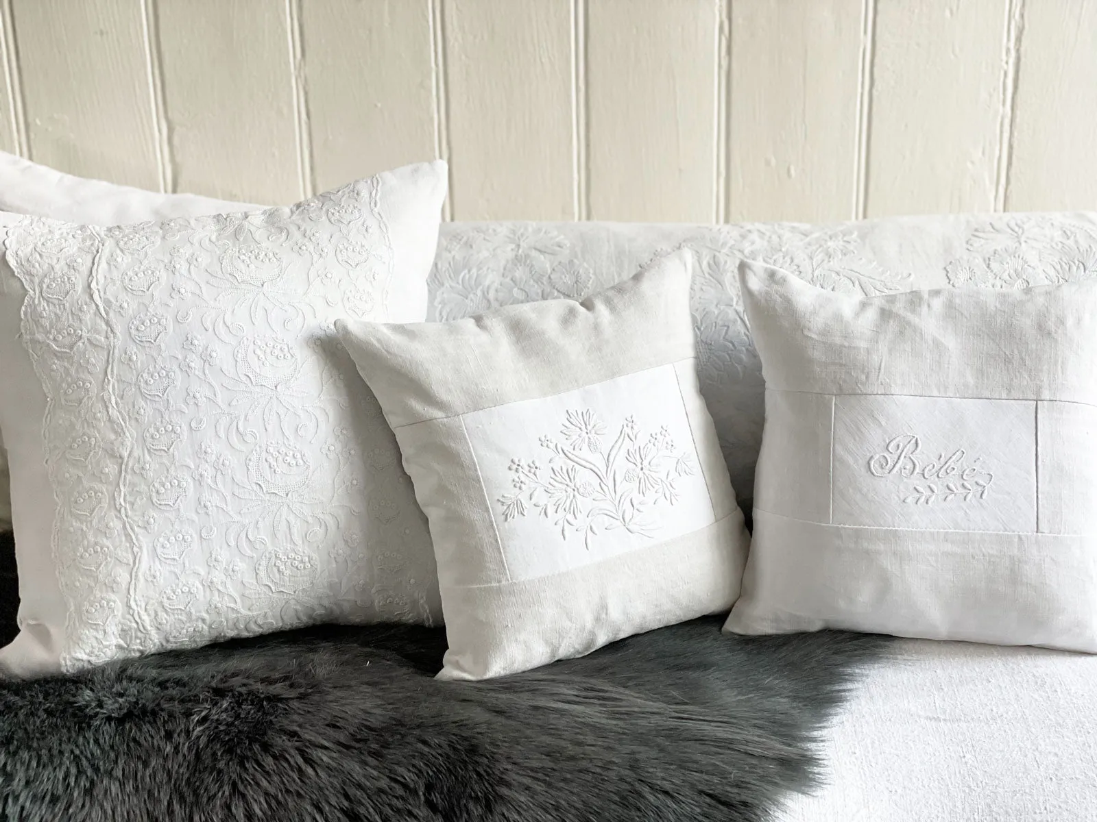 Bébé - An Antique French White on White 'Bébé' Embroidered 30cm Cushion
